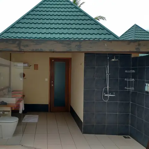 Teilweise offenes Badezimmer mit Dusche unter freiem Himmel und zwei Waschbecken